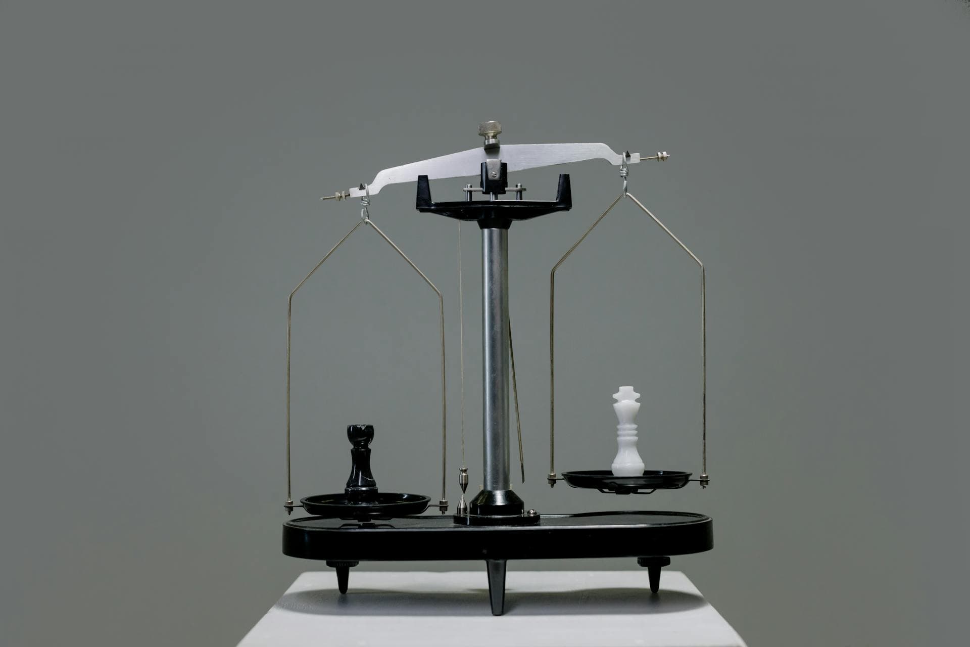 Chess pieces on a scale representing Cosmolex vs. PCLaw